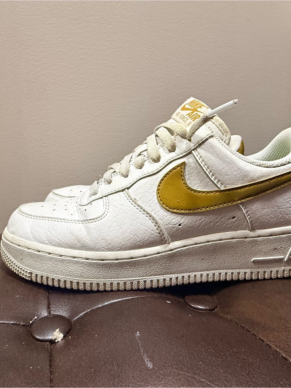 Nike Women's Low-Top Sneakers in White with Gold Swoosh